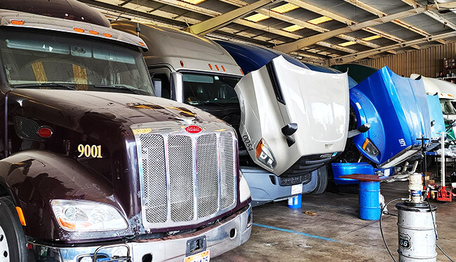 Big Rig Trucks being repaired at a truck mechanics shop